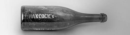 Old Hancock's Imperial Ale bottle lying on its side